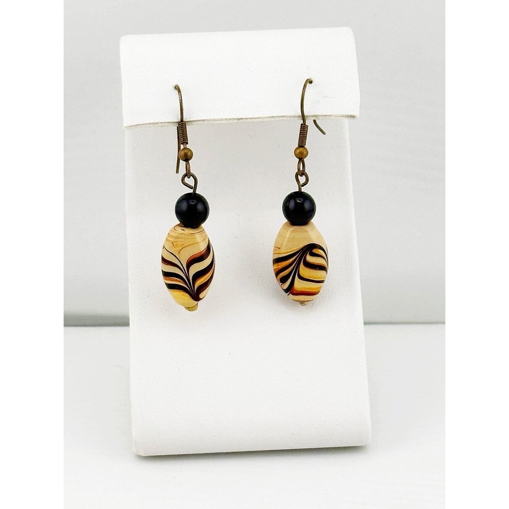 Artisan crafted earthtones dangly glass earrings with beads at top.